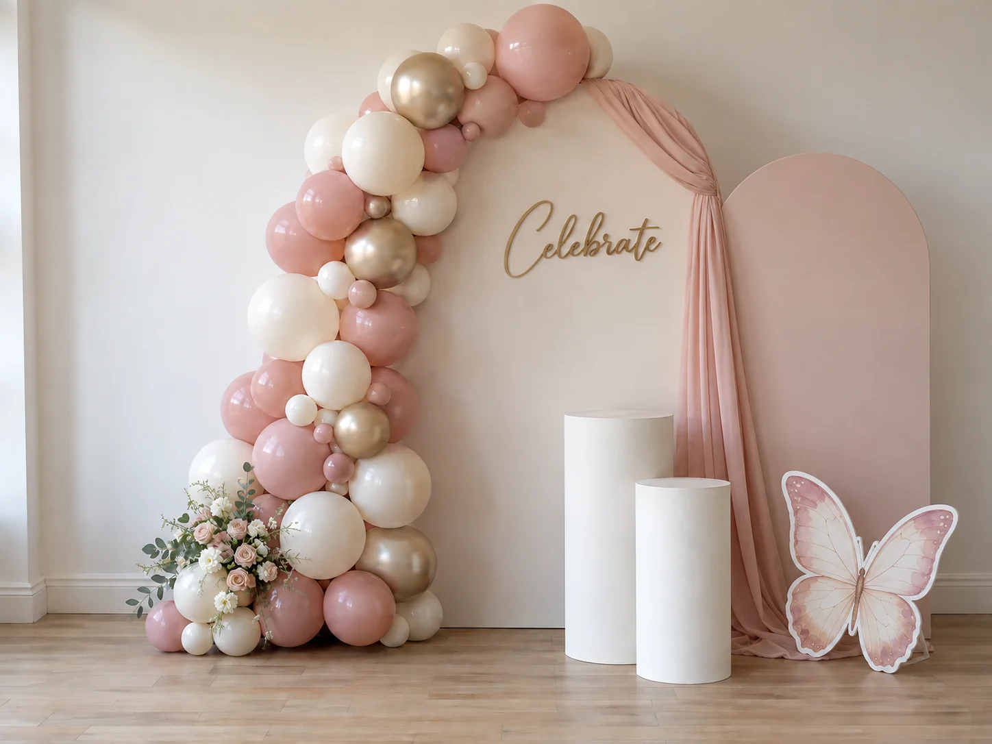 Styled Celebration package styled with an arch backdrop, balloon garland and plinths